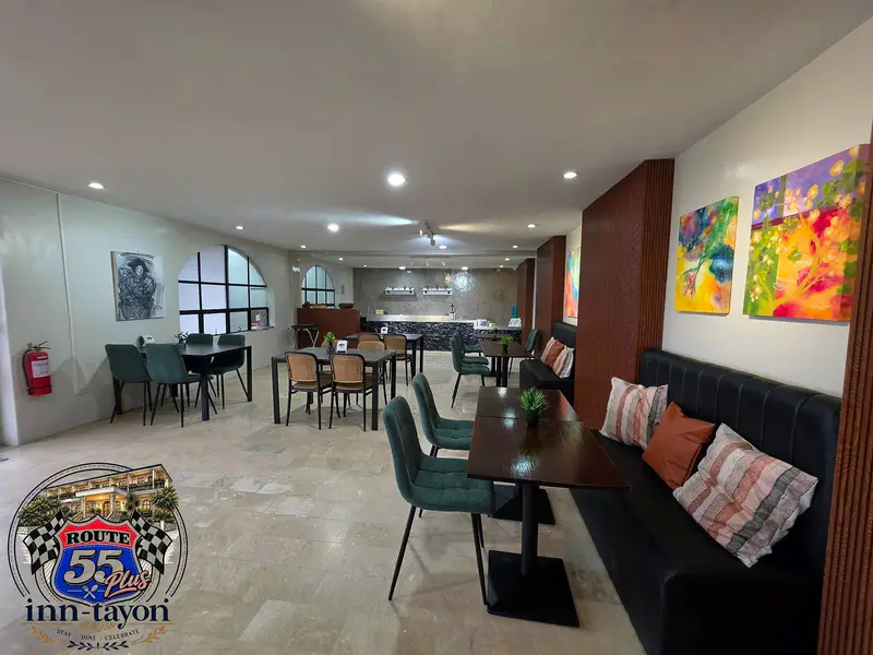 Route 55+ dining room with cushioned booth seating and bright paintings
